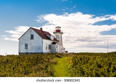 close view of old lighthouse and guardian house  in Longue-Pointe-de-Mingan, Quebec, Canada