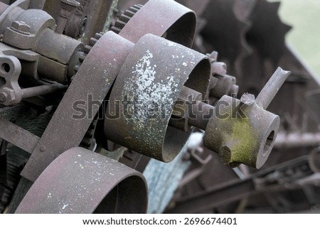 Close up view of old rusty obsolete farm equipment details.