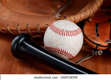 Close View On A Baseball. Mitt Gloves And Handle Of A Bat. Catcher And Hitter Equipment.