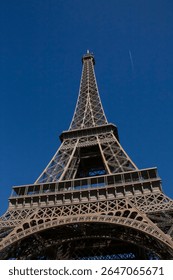 close up view on Eiffel Tower in Paris against blue sky