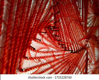 Close Up View On Homemade Red String Art Abstract Pattern And Needles. Arts And Crafts For Kids. Mathematics Pursuit Polygons. Thread Nails School Project Children Fun Handmade Diy Creative 