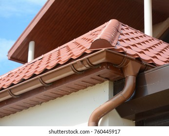 Close Up View On House Metal Roof Problem Areas For Rain Gutter Waterproofing Outdoor. Home Guttering, Gutters, Plastic Guttering System, Guttering & Drainage Pipe Exterior. Roofing Repair.