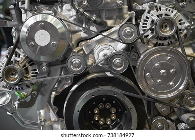 Close up view on new truck diesel engine motor belt, pulleys, gears, alternator and other engine equipment. Assembled truck diesel engine. Abstract auto automotive industrial background pattern