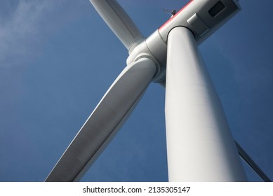 Close Up View On An Offshore Wind Turbine With A Blue Sky On The Background