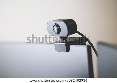 close up view on a portale computer webcam attached on the top of a monitor, technology, communication and work concepts, enterprise work, communications technologies