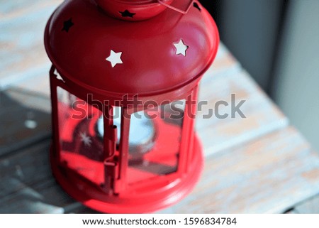 Close up view on red old style candle house on wooden surface