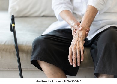 Close up view on the shaking hand of the senior woman,symptom of resting tremor or parkinson's disease,old elderly patient holding her wrist to control hand tremor,neurological disorders,brain problem - Shutterstock ID 1836064441