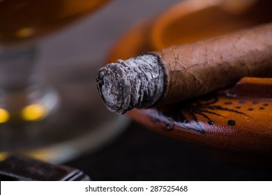 Close View On Smoking Cuban Cigar With Ash