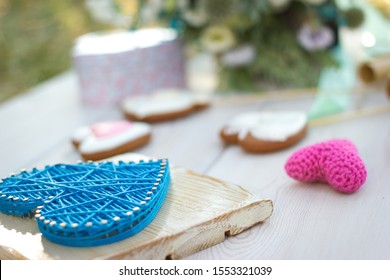 Close Up View On String Art And Crochet Heart Shaped Wedding Decor. Heart Shaped Cookies On A Stick