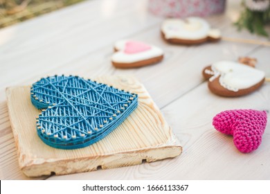 Close Up View On String Art And Crochet Heart Shaped Wedding Decor. Heart Shaped Cookies On A Stick