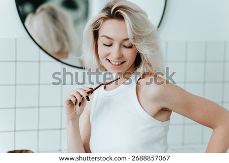 Close up view on toothbrush with toothpaste in smiling blonde woman hand. Whitening, morning routine
