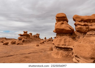 Close up view on unique eroded Hoodoo Rock Formations at Goblin Valley State Park in Utah, USA, America. Sandstone rocks called goblins which are mushroom-shaped rock pinnacles. Overcast day in summer - Shutterstock ID 2325056097