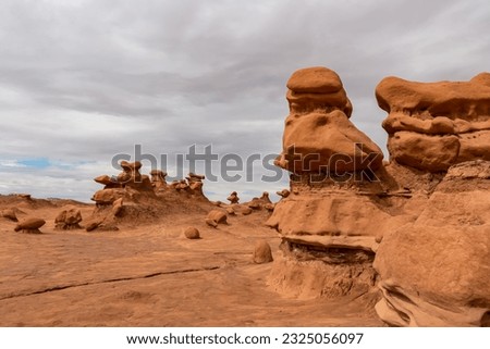 Close up view on unique eroded Hoodoo Rock Formations at Goblin Valley State Park in Utah, USA, America. Sandstone rocks called goblins which are mushroom-shaped rock pinnacles. Overcast day in summer