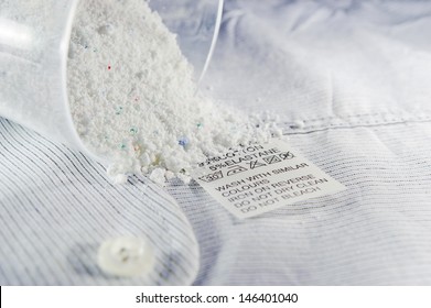 Close Up View On An Washing Label Tag And Washing Powder.