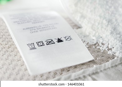 Close Up View On An Washing Label Tag And Washing Powder.