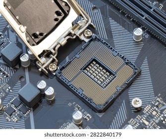 A close up view of an open CPU socket on a modern computer motherboard showing the pins