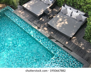 close up view of outdoor daybeds and swimming pool