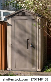 A Close Up View Of A Outside Plastic Shed Or Storage Unit That Has A Small Lock On It Out In The Small Garden 