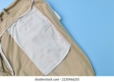 Close Up View Of A Pant Pocket Isolated On A Blue Background. Fashion Design Concept