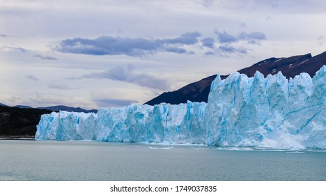 Close View Of Perito Moreno Glacier Ice Wall Above The Water