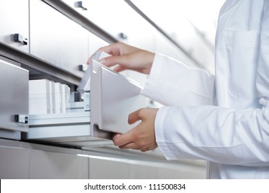 Close Up View Of Pharmacist Taking Medicine From Drawer