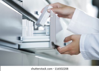 Close Up View Of Pharmacist Taking Medicine From Drawer