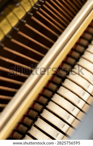 Close view of piano keys and strings during music practice in a home setting