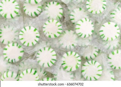 Close View Of Plastic Wrapped Spearmint Starlight Mints On A Tray.