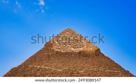 Close up view of the polished limestone cap of the Great Pyramid of Khafre at the Giza plateau against bright clear blue skies on the Giza Plateau near Cairo,Egypt