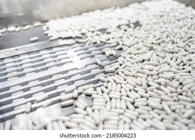 Close Up View Of Process Production Line White Capsules Supplement, Medical Industry Concept.