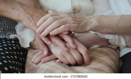 Close view of putting old female hands on hands together of three grandmothers at camera. 4K