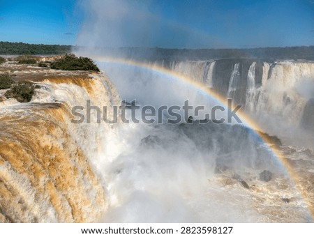 Close View of a Rainbow Arching through the Mist beside Iguazu Falls