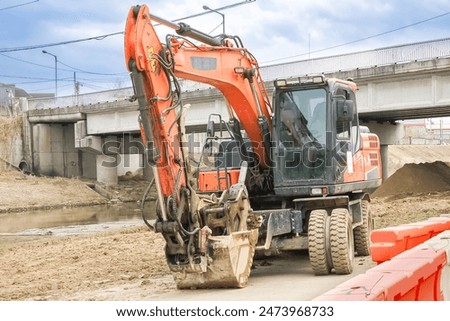 close up view of red backhoe