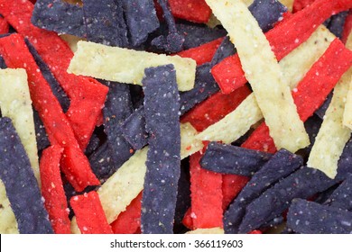 A Close View Of Red Blue And Natural Tortilla Strips.