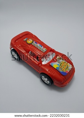 Close up view of red racing car toy isolated on white background.