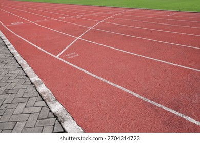 Close Up View of Red Running Track Lanes on Sport Field