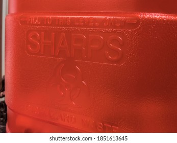 Close Up View Of A Red Sharps Medical Waste Container Inside A Medical Office