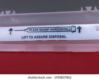 Close Up View Of A Red Sharps Medical Waste Container Inside A Medical Office