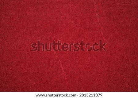 Close view of a red textured surface with subtle sheen.