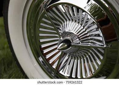 Close View of Restored Antique Die-Cast Chrome Plated "Jet Fan" 3-Bar Hubcap with Rocket-Style Center Automobile Wide Whitewall Tire