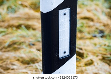 A close up view of a roadside delineator post