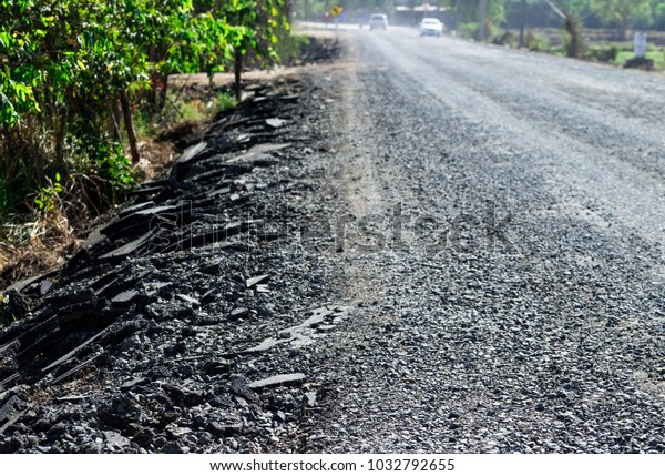 Close up view. Rock debris and road surface under
renovation and repair.