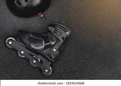 Close Up View Of Roller Skates Or Rollerblading On Road Surface