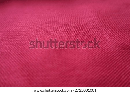 Close view of ruby red unprinted dense cotton fabric