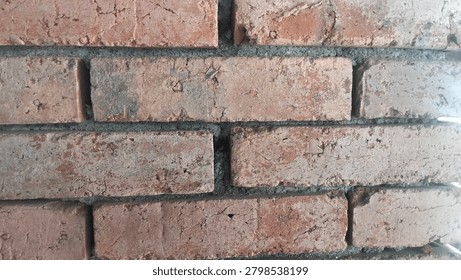 a close up view of a rustic red brick wall