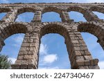 Close Up view of the Segovia Aquaduct with a view of the blue skies through the arches