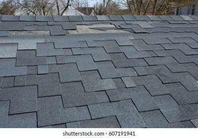 A Close Up View Of Shingles A Roof Damage.