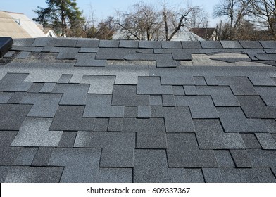 A Close Up View Of Shingles A Roof Damage.