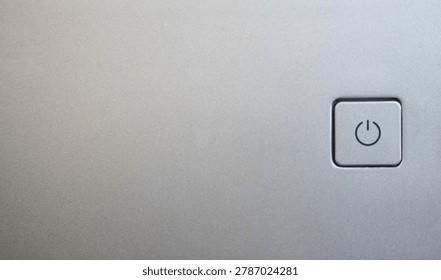 Close up view of a silver power button with the onoff symbol, representing technology, control, and functionality