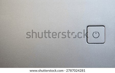 Close up view of a silver power button with the onoff symbol, representing technology, control, and functionality